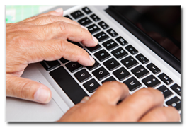 Older Job Seeker Typing on Keyboard
