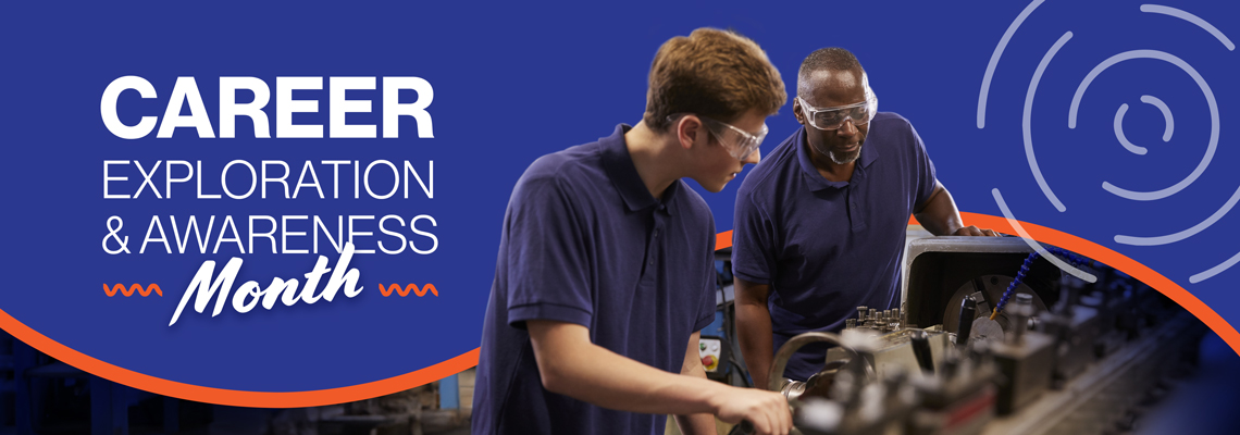 A young apprentice wearing safety glasses learning to operate a machine lathe under the supervision of an experienced machinist.